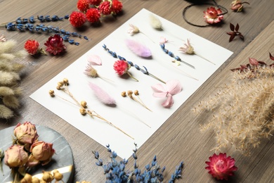 Photo of Composition with beautiful dry flowers on wooden background