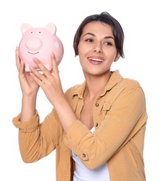 Photo of Young woman with piggy bank on white background