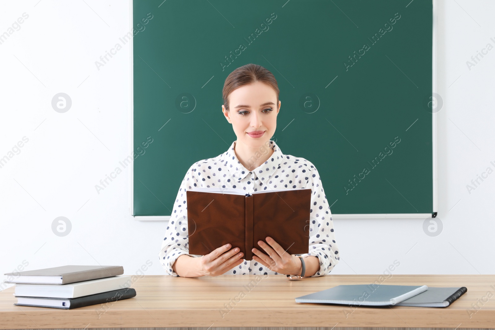 Photo of Portrait of young female teacher in classroom