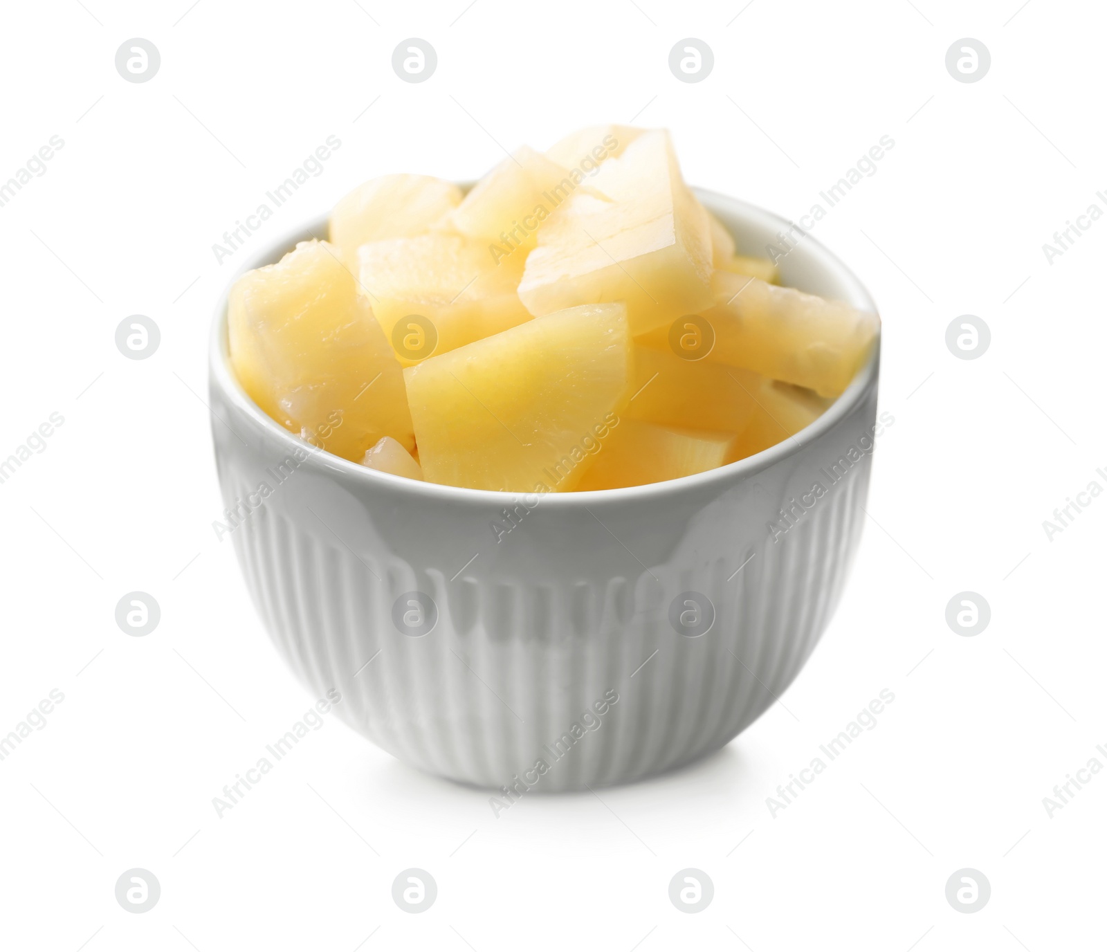 Photo of Pieces of canned pineapple in bowl on table, closeup