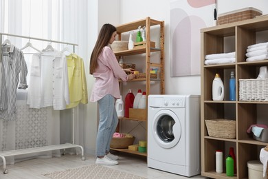 Young woman with sponges in laundry room