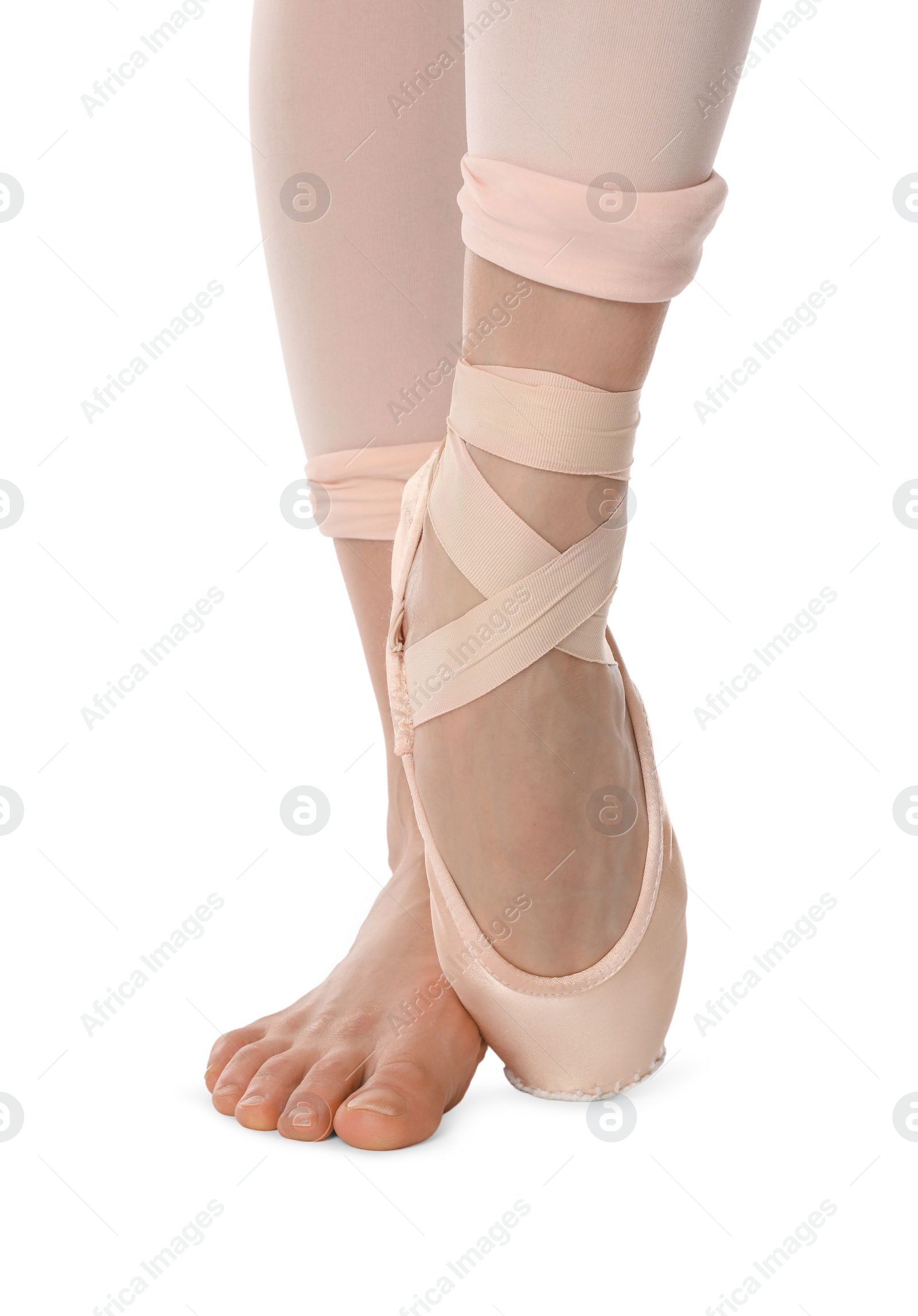 Photo of Ballerina in pointe shoe dancing on white background, closeup