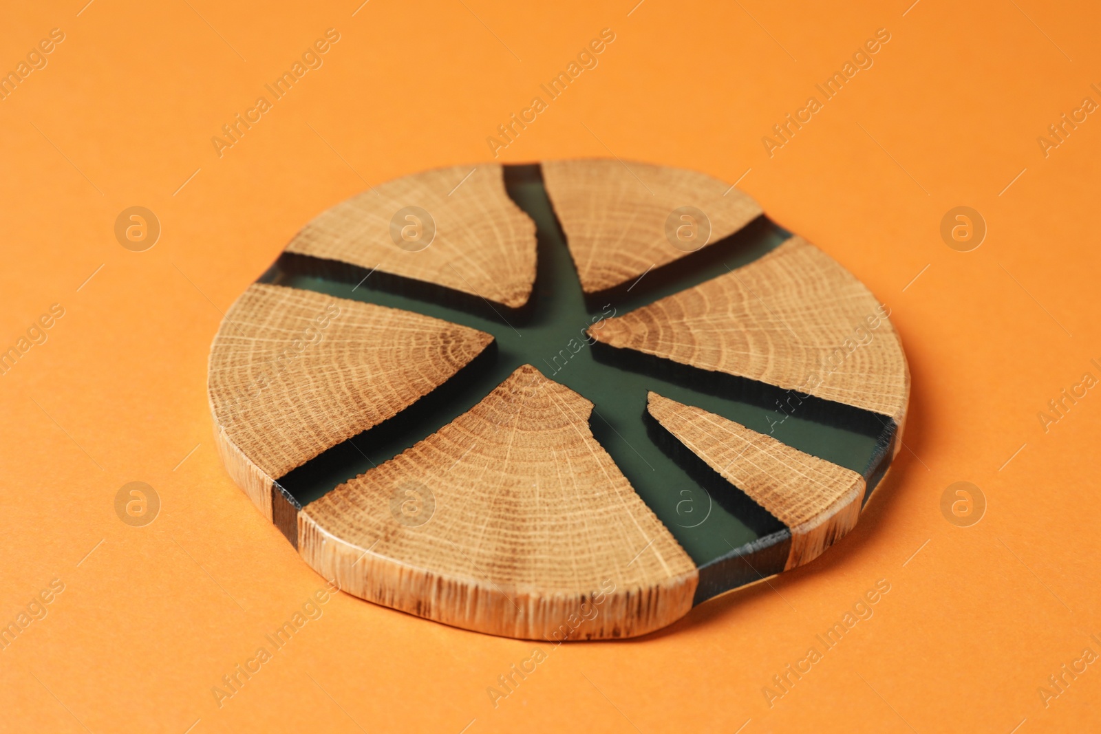 Photo of One stylish cup coaster on orange background, closeup