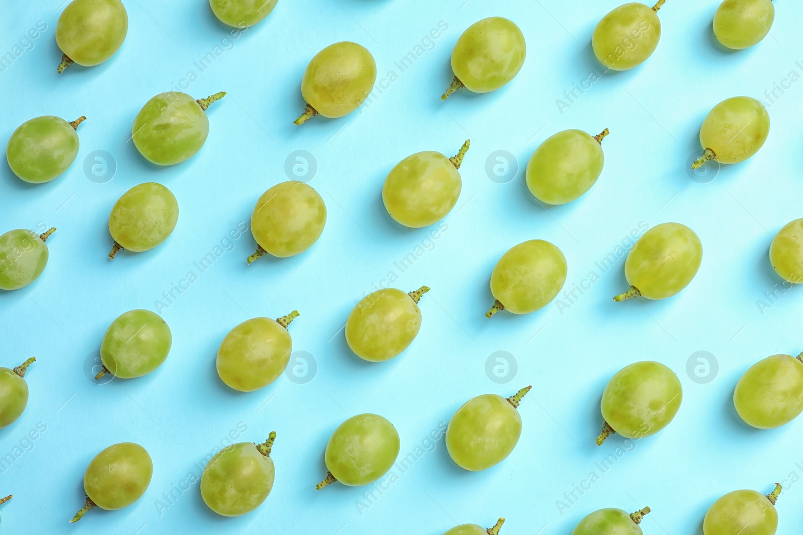 Photo of Fresh ripe juicy green grapes on color background, top view