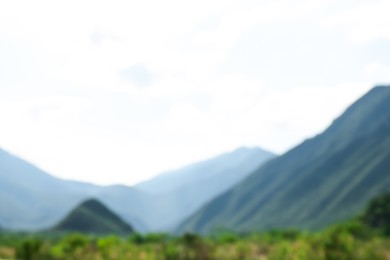 Blurred view of high mountains under sky outdoors