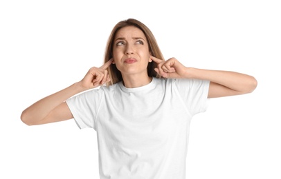 Photo of Emotional young woman covering her ears with fingers on white background