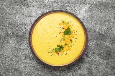 Photo of Delicious creamy corn soup on grey table, top view