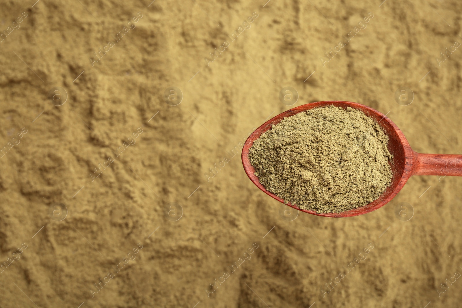 Photo of Spoon and hemp protein powder, top view with copy space