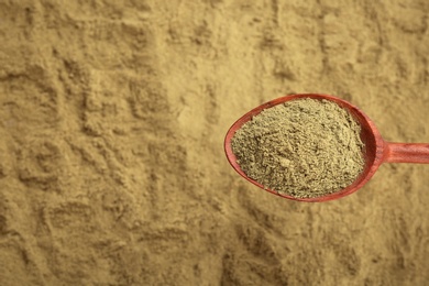 Photo of Spoon and hemp protein powder, top view with copy space