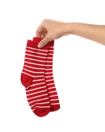 Woman holding pair of cute child socks on white background, closeup