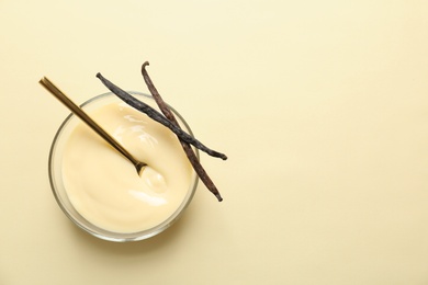 Photo of Vanilla pudding and sticks on color background