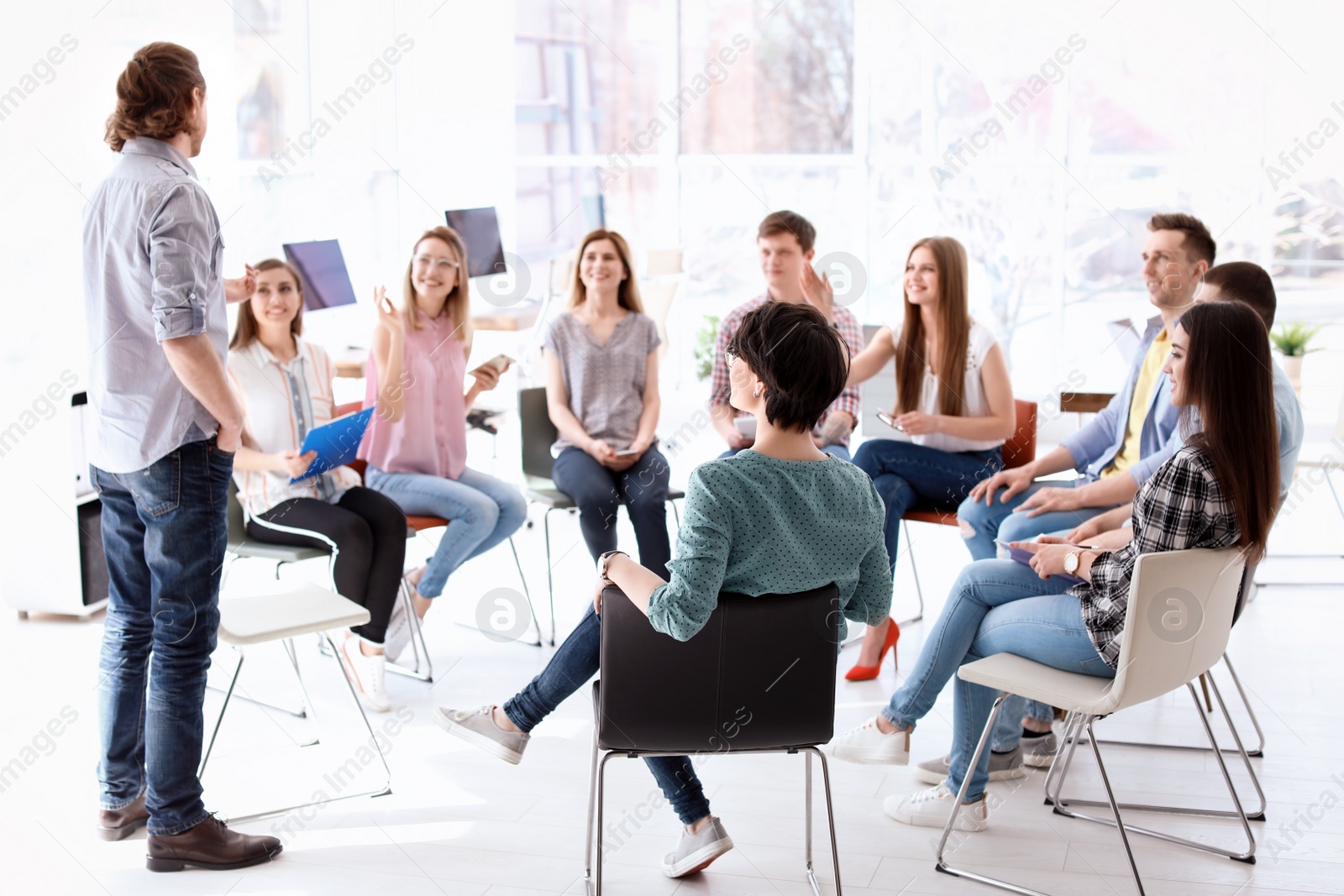 Photo of Male business trainer giving lecture in office