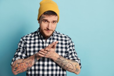 Photo of Portraithandsome hipster man on light blue background. Space for text