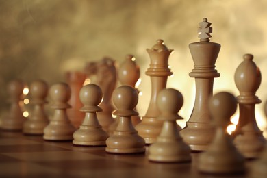 Photo of Wooden chess pieces on checkerboard before game, selective focus