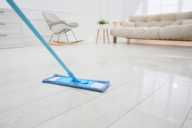 Photo of Washing of parquet floor with mop in room, closeup. Space for text