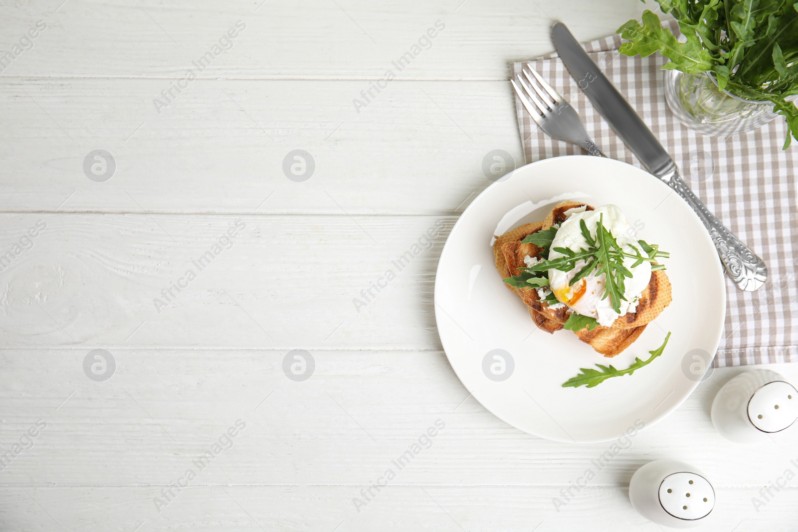 Photo of Delicious sandwich with arugula and egg on white wooden table, flat lay. Space for text