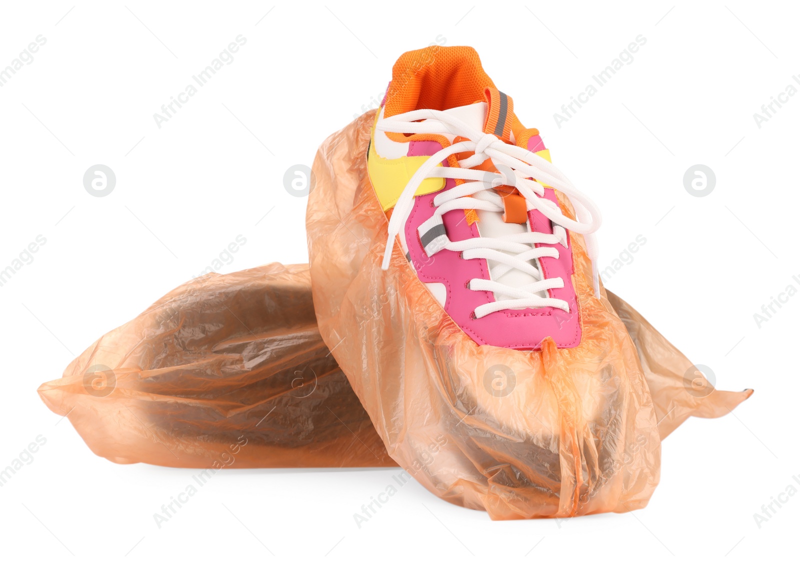 Photo of Sneakers in shoe covers isolated on white