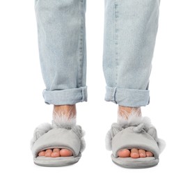 Photo of Woman in grey soft slippers on white background, closeup