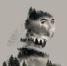 Double exposure of beautiful woman and foggy mountains