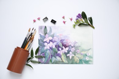 Flat lay composition with watercolor paints and floral picture on white background