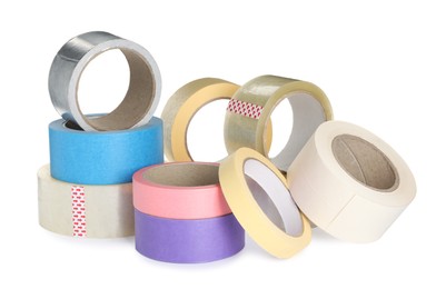 Many different rolls of adhesive tape on white background