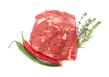 Photo of Fresh raw beef cut, herbs and peppers isolated on white, top view