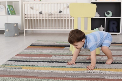 Photo of Cute baby crawling at home