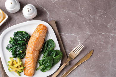 Photo of Tasty salmon with spinach and avocado served on marble table, flat lay. Space for text