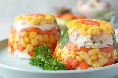 Photo of Delicious fish aspic with vegetables on plate, closeup