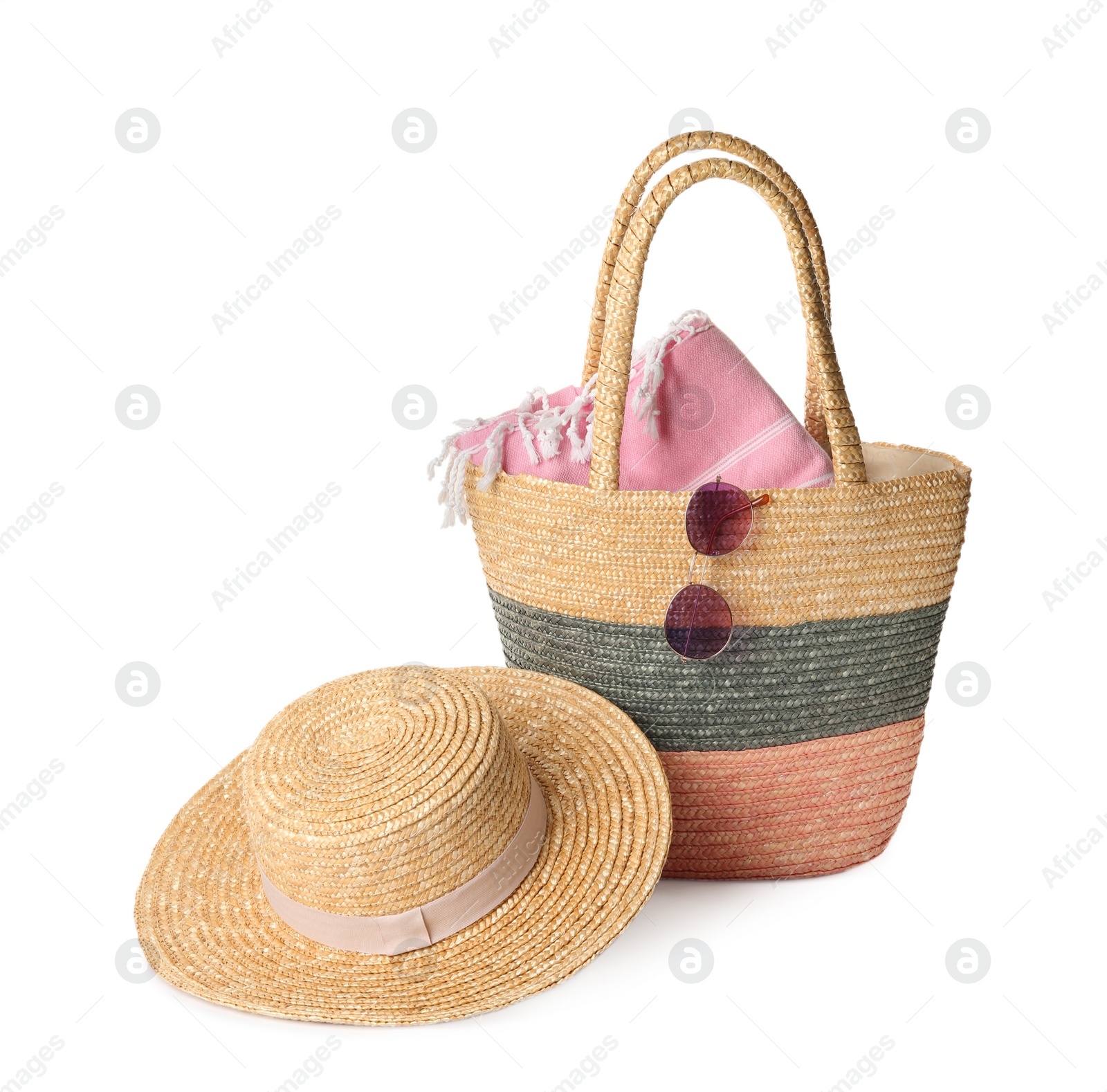 Photo of Stylish straw hat, beach bag and sunglasses on white background