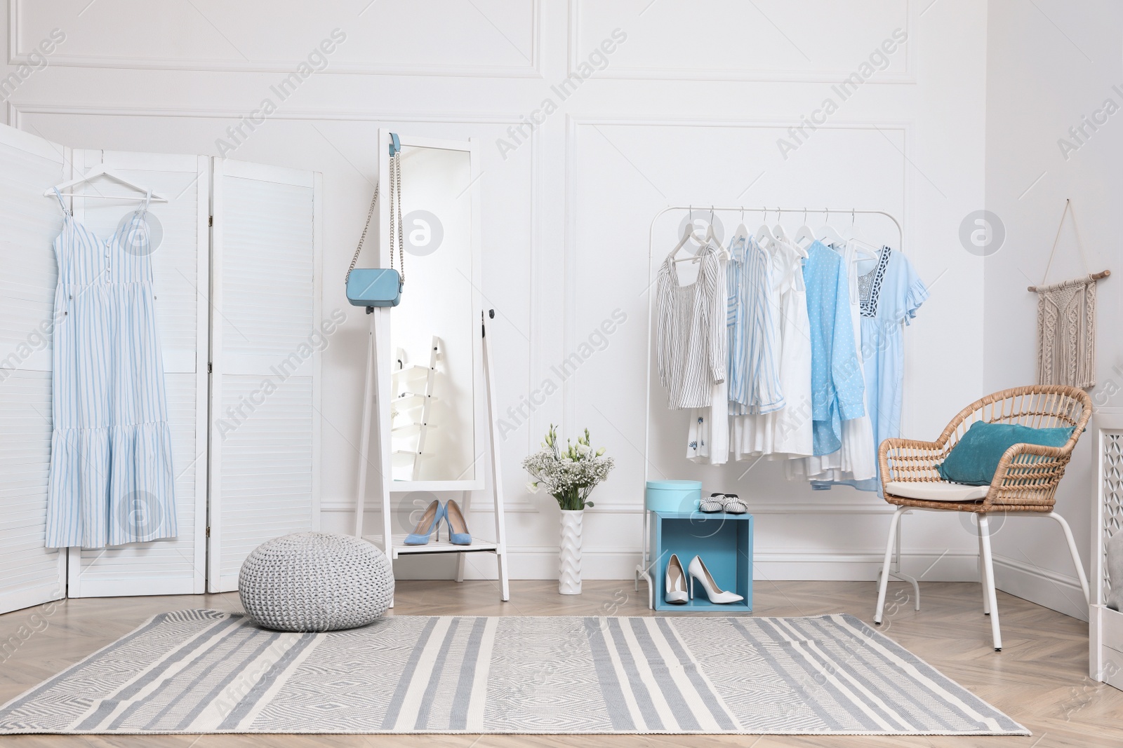 Photo of Dressing room with stylish clothes, shoes and accessories. Elegant interior design