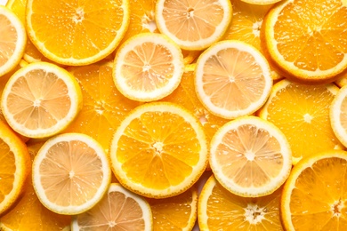 Slices of citrus fruits as background, top view