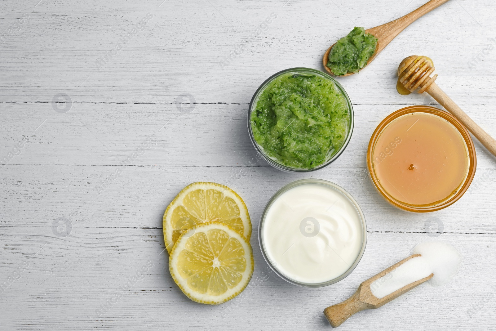 Photo of Handmade face mask made and different ingredients on white wooden table, flat lay. Space for text