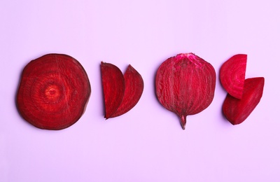 Photo of Flat lay composition with cut raw beets on pink background