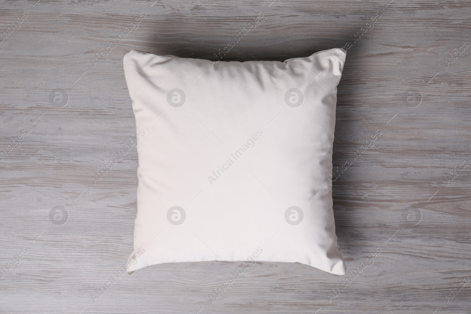 Photo of Blank soft pillow on wooden background, top view