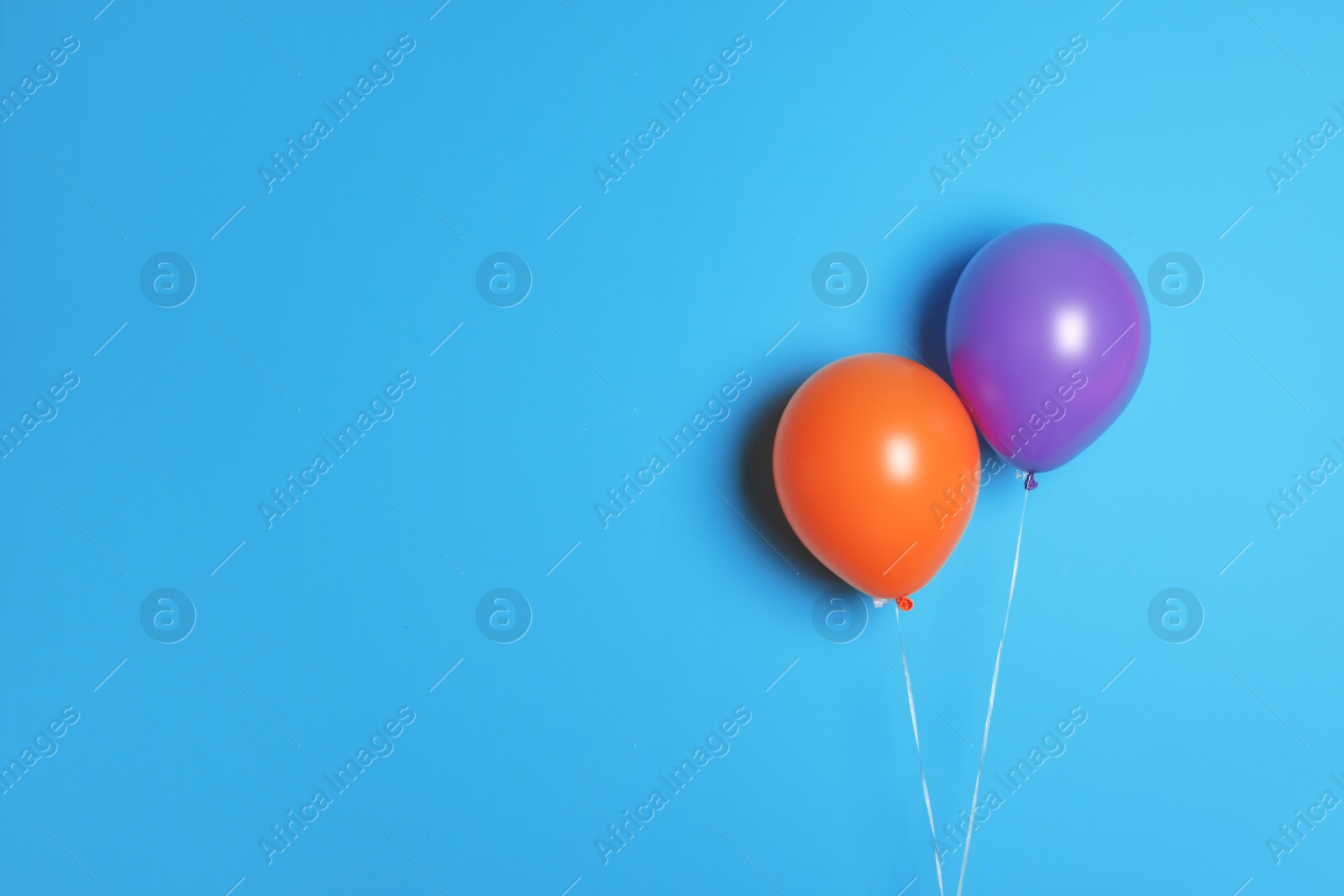 Photo of Different balloons on color background. Celebration time