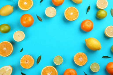 Flat lay composition with tangerines and different citrus fruits on blue background. Space for text