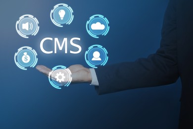 Image of CMS. Man using virtual screen, closeup. Scheme with icons on blue background