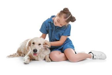 Photo of Cute little child with her pet on white background