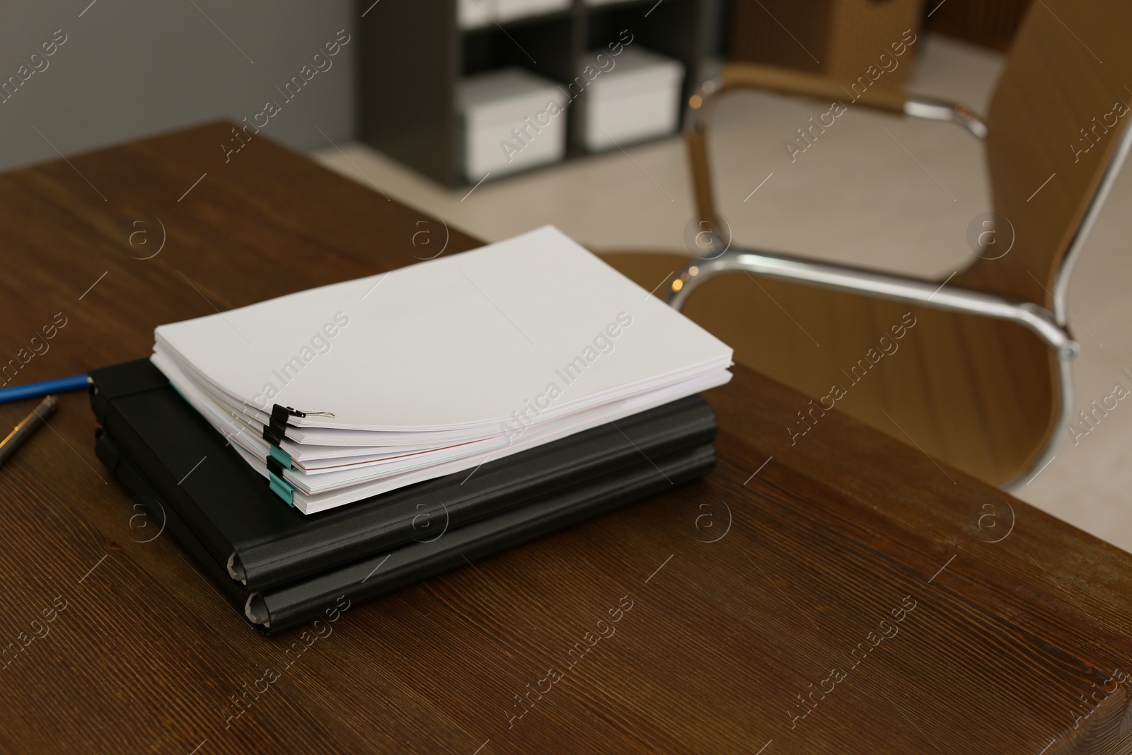 Photo of Stack of documents on wooden table in office. Space for text