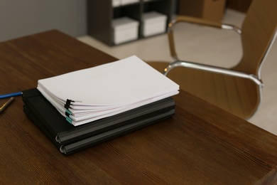 Photo of Stack of documents on wooden table in office. Space for text