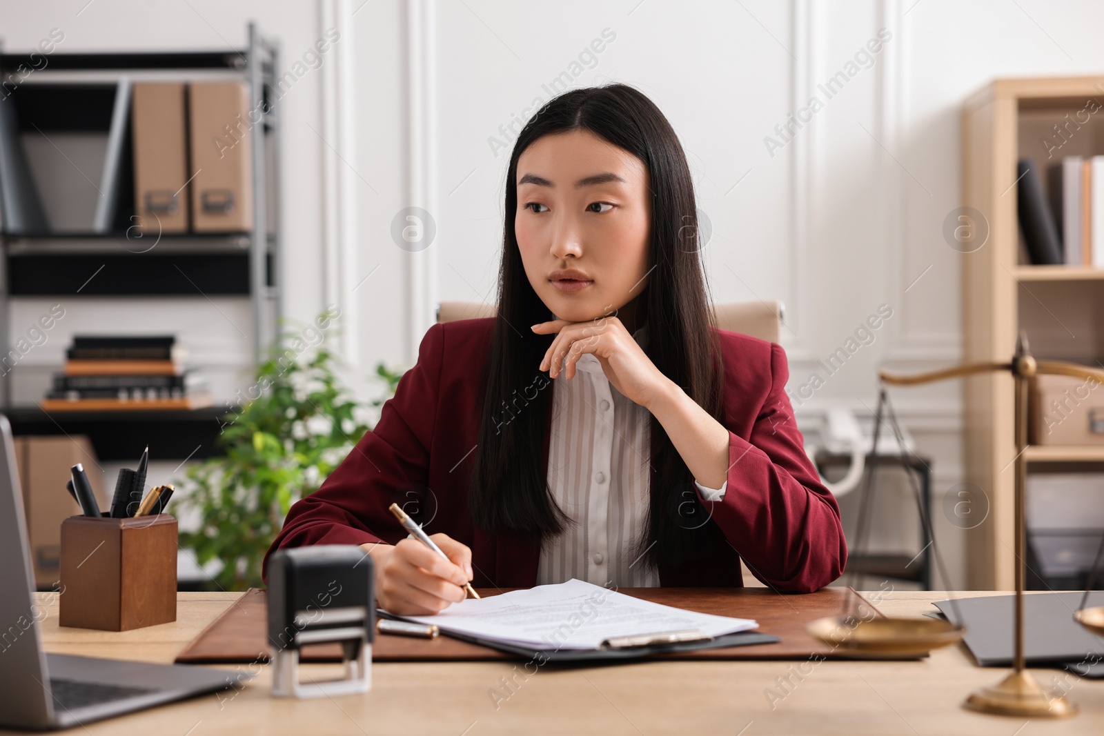 Photo of Portrait of notary at table in office