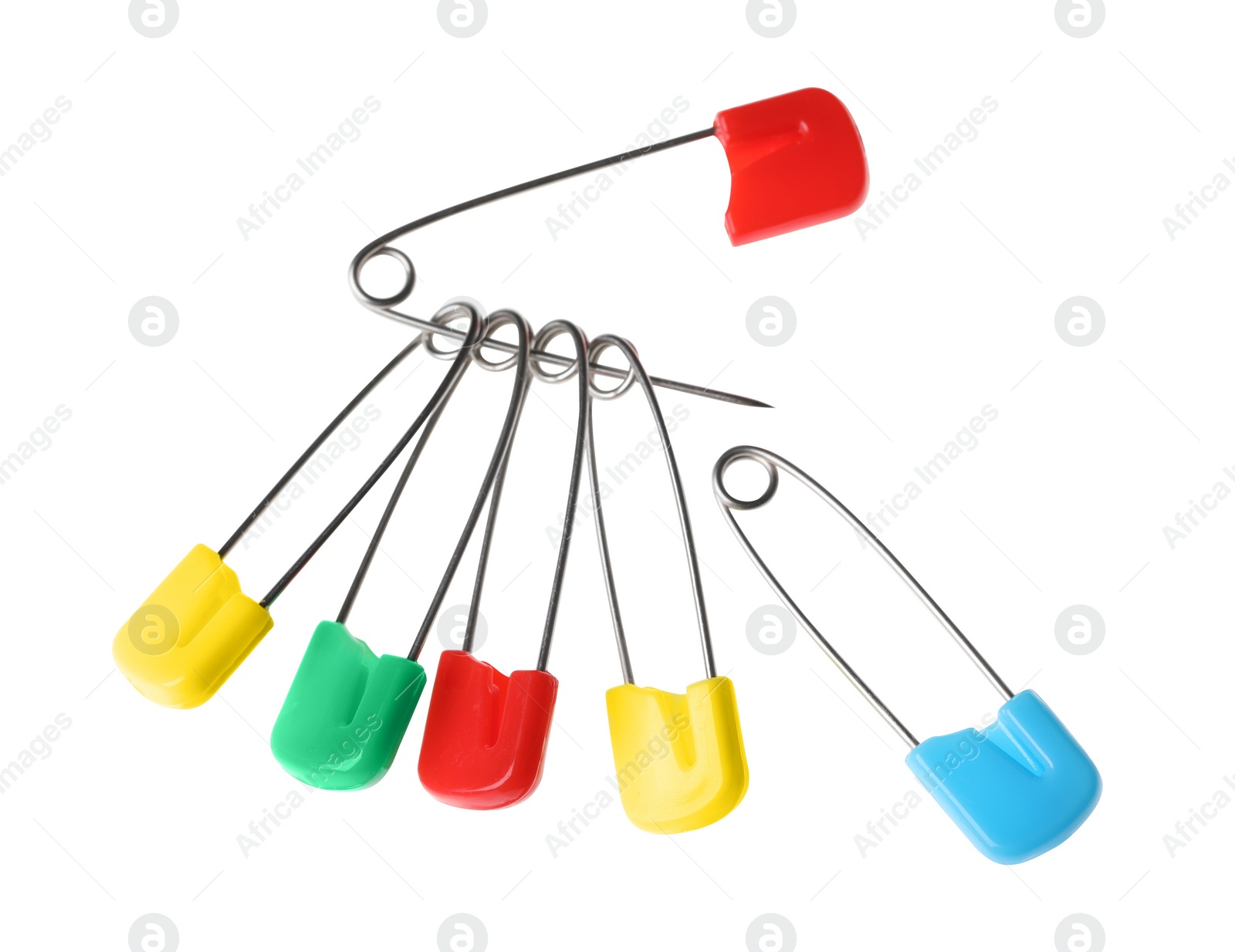 Photo of New colorful safety pins on white background
