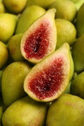 Photo of Halves of green fig on fresh fruits, closeup
