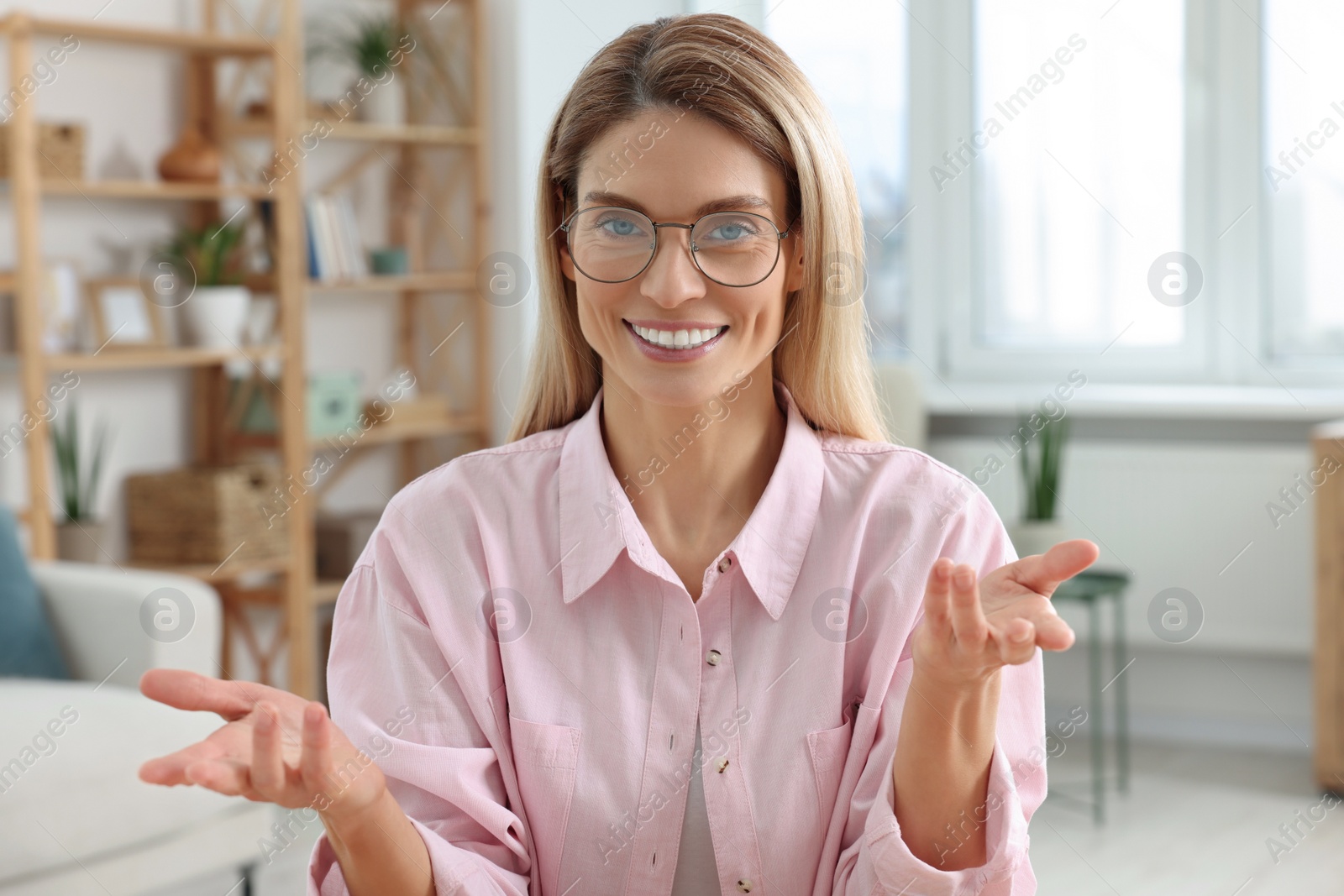 Photo of Happy woman having video call at home, view from web camera