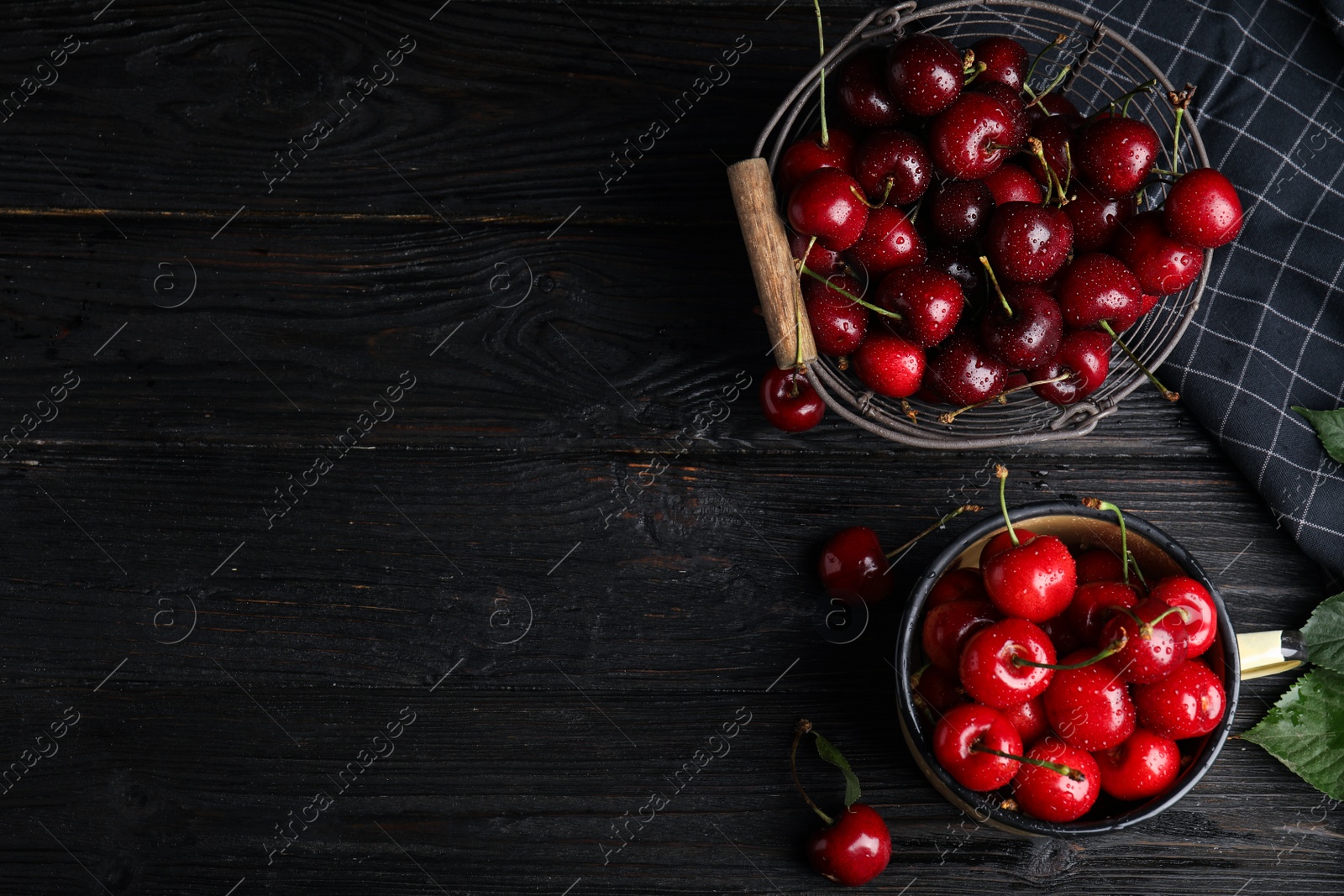 Photo of Flat lay composition with sweet cherries on dark wooden table. Space for text