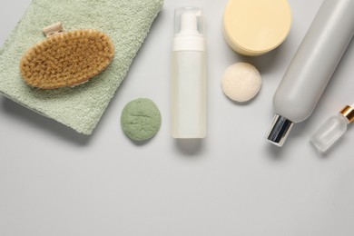 Photo of Bath accessories. Flat lay composition with personal care products on light grey background, space for text