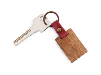 Photo of Key with wooden keychain isolated on white, top view