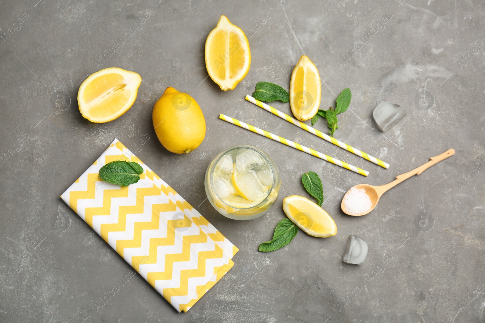 Photo of Flat lay composition with delicious natural lemonade on gray background