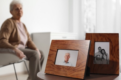 Framed photos and blurred female pensioner on background. Space for text